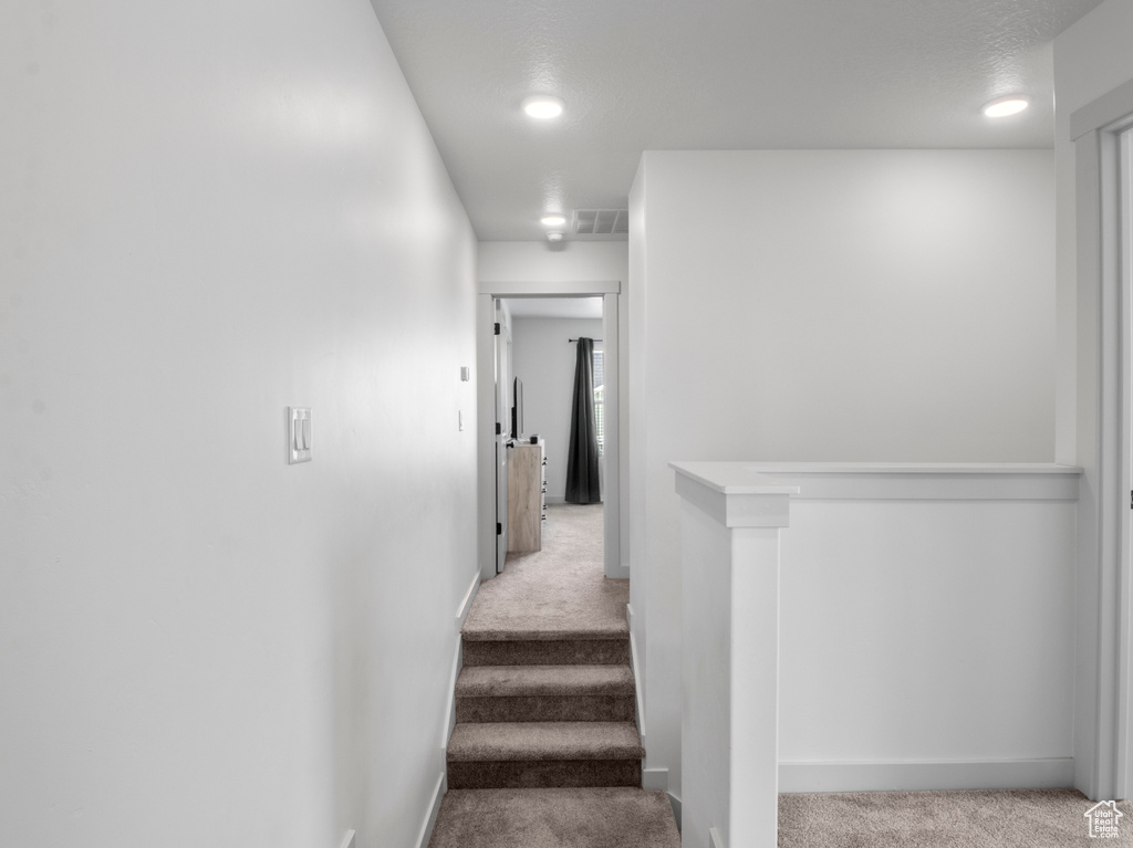 Staircase featuring carpet flooring, recessed lighting, baseboards, and visible vents