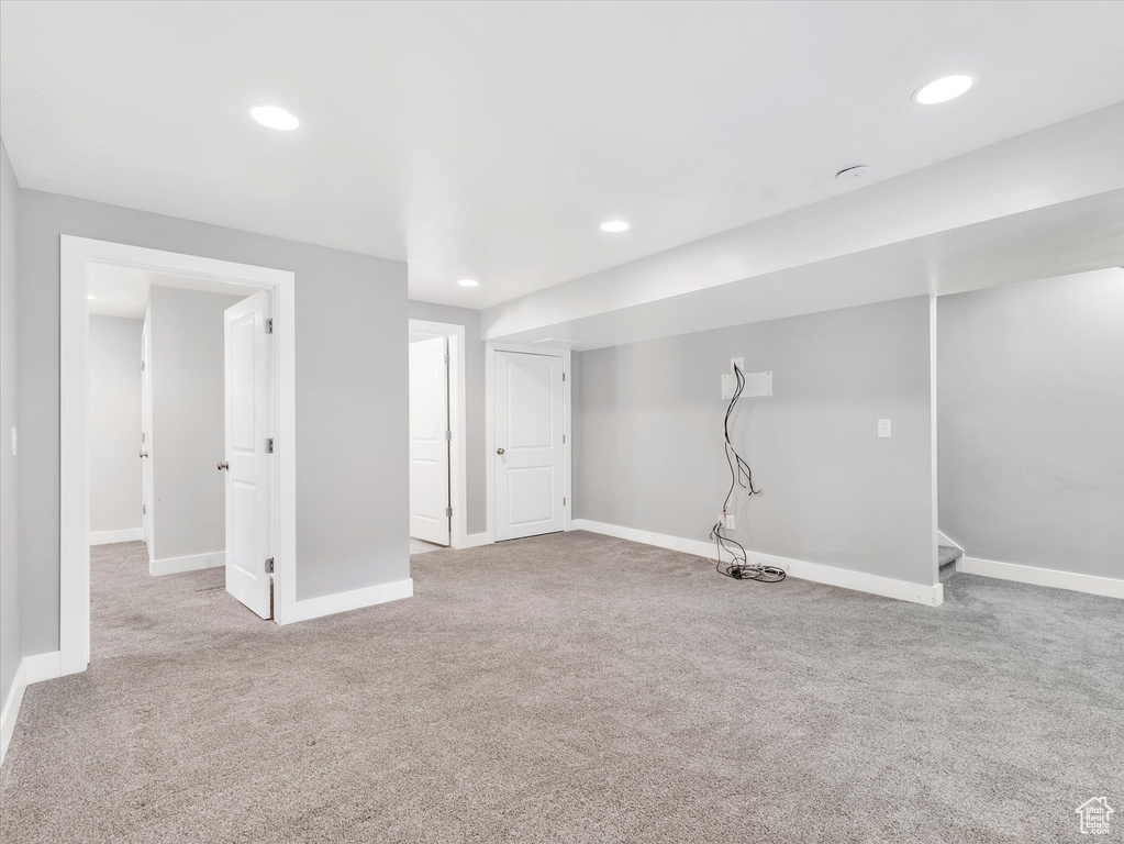 Finished basement featuring carpet floors and baseboards