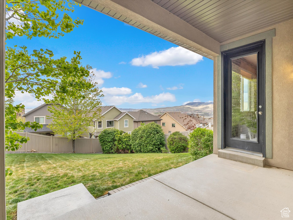 Exterior space with a patio, fence, and a residential view