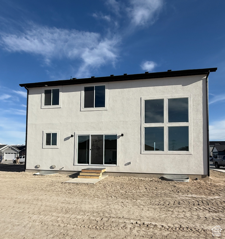 Rear view of property featuring stucco siding