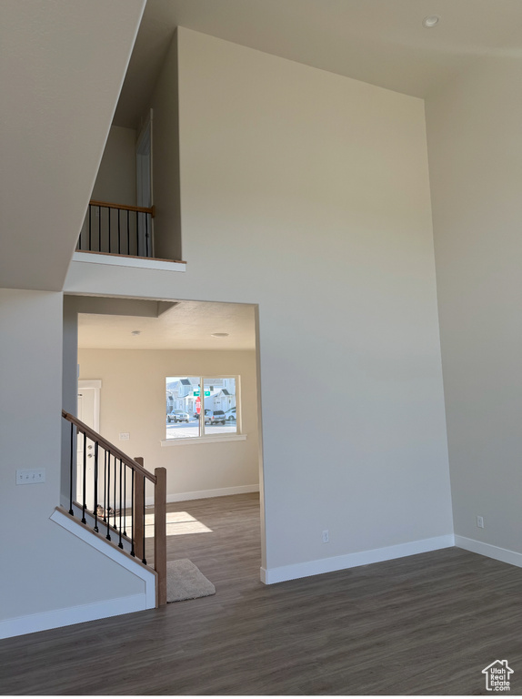 Staircase with baseboards, recessed lighting, and wood finished floors