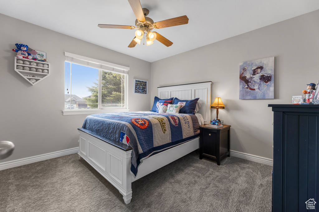 Bedroom with a ceiling fan, baseboards, and carpet