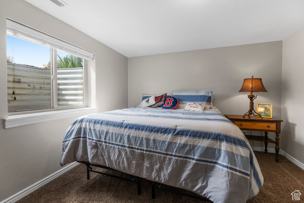 Bedroom featuring baseboards and carpet flooring