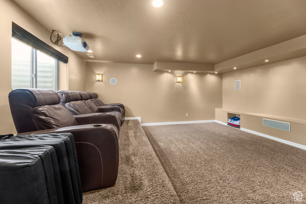 Carpeted cinema with baseboards, recessed lighting, a textured ceiling, and visible vents