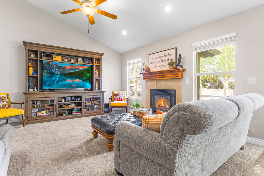 Living area with carpet flooring, a tiled fireplace, a ceiling fan, recessed lighting, and vaulted ceiling