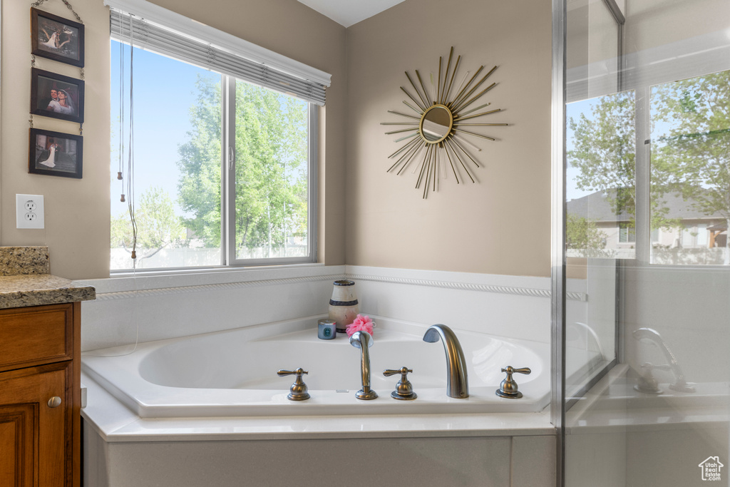 Full bathroom with a bath and vanity