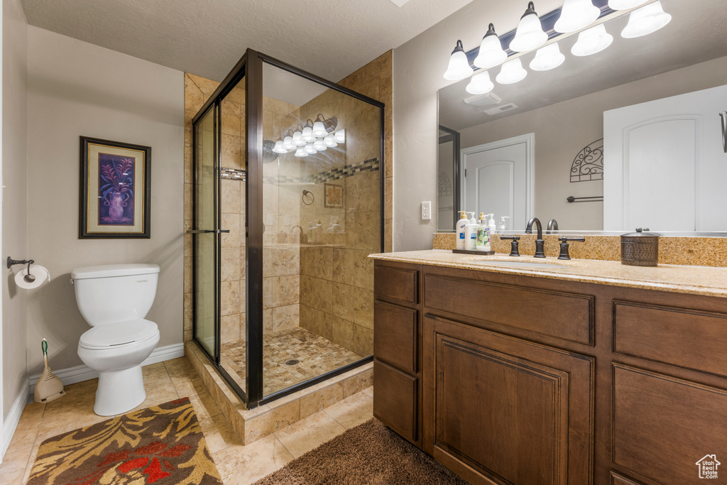 Full bathroom with visible vents, a stall shower, vanity, tile patterned floors, and toilet