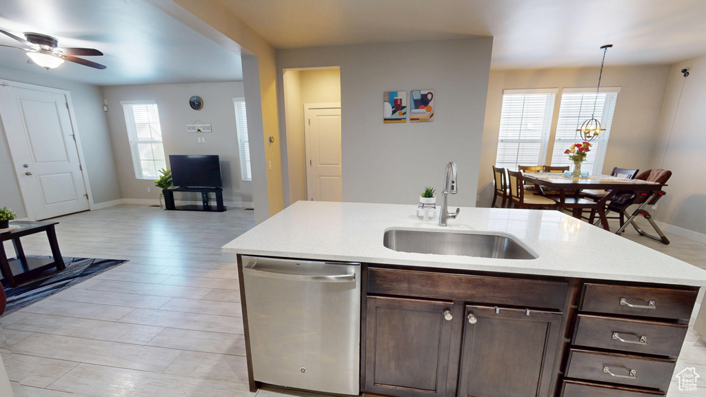 Kitchen featuring stainless steel dishwasher, a sink, a ceiling fan, and dark brown cabinets