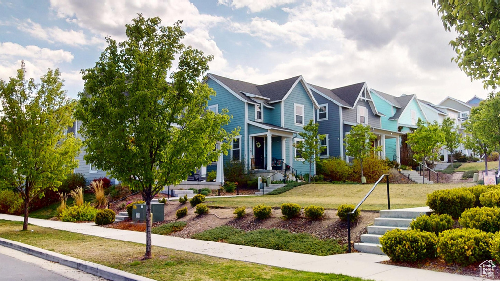 View of front of house with a residential view and a front lawn