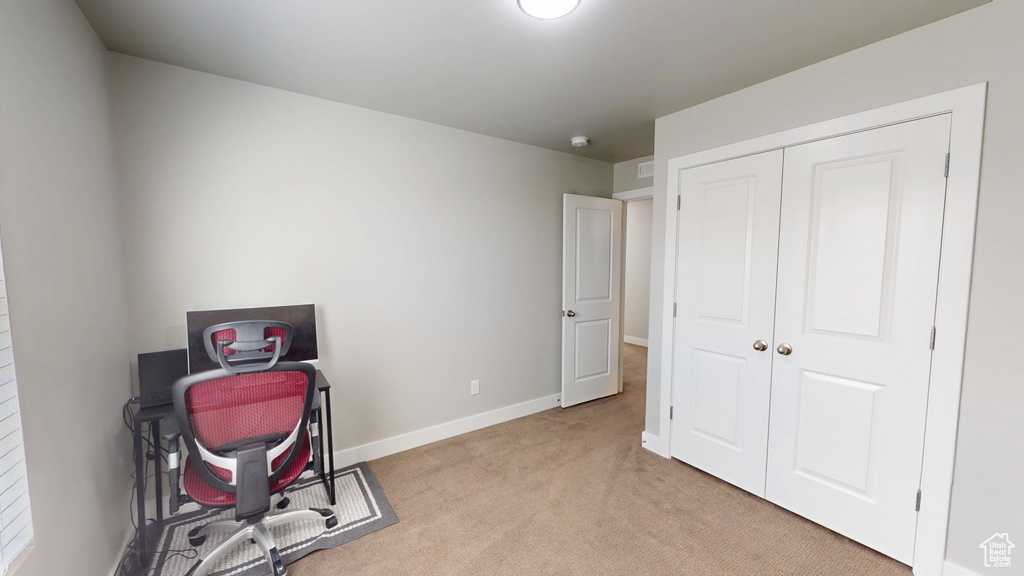 Office featuring light colored carpet and baseboards