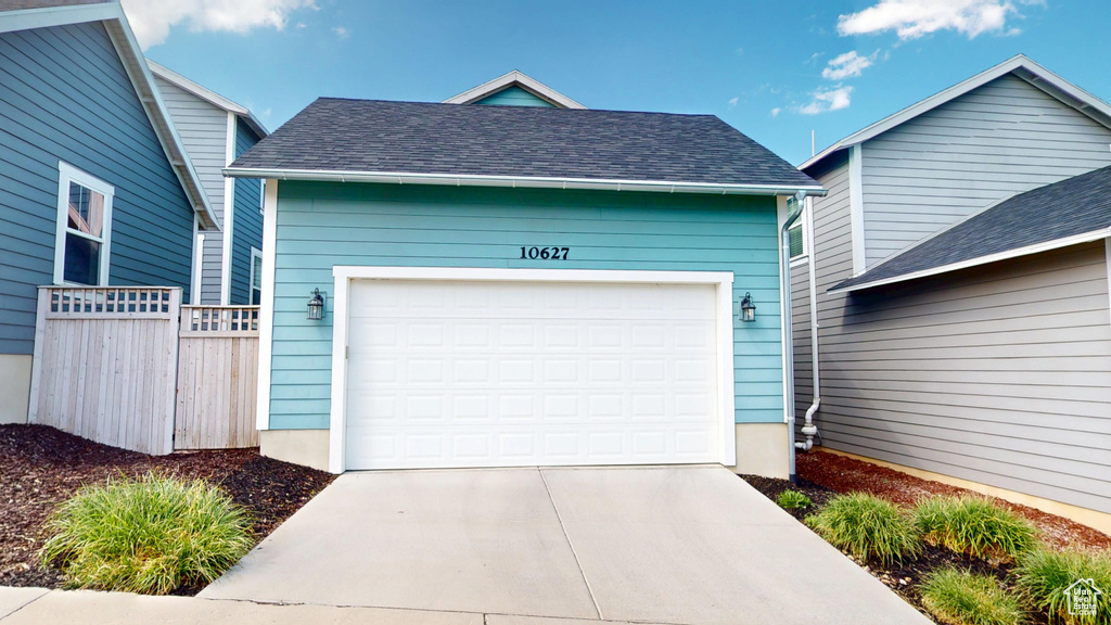 Garage with fence and driveway