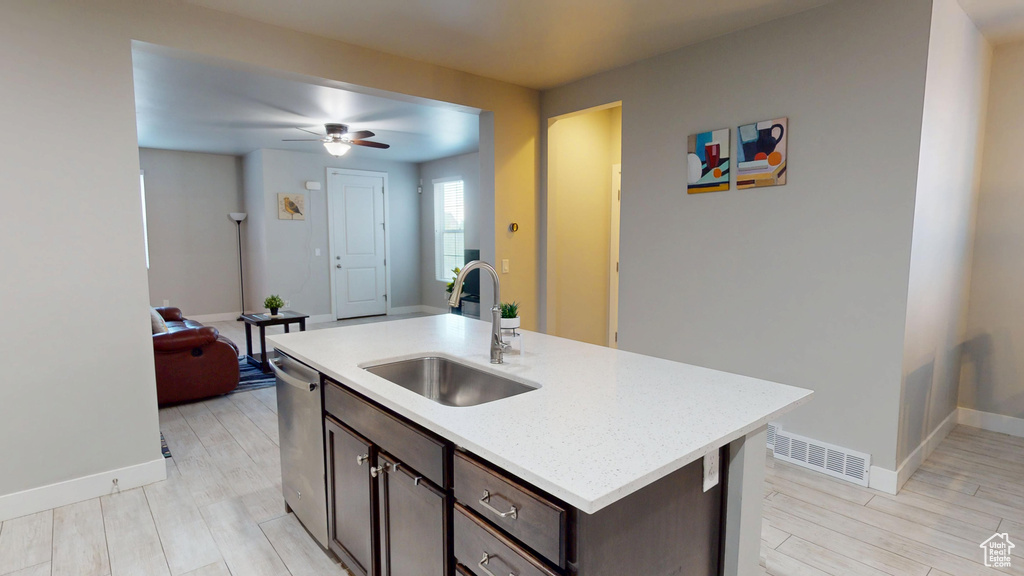 Kitchen featuring dark brown cabinetry, a sink, dishwasher, a ceiling fan, and baseboards
