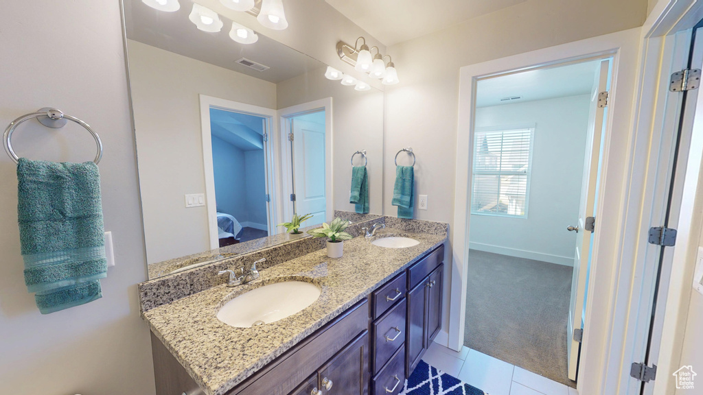 Full bathroom with visible vents, a sink, ensuite bathroom, and double vanity