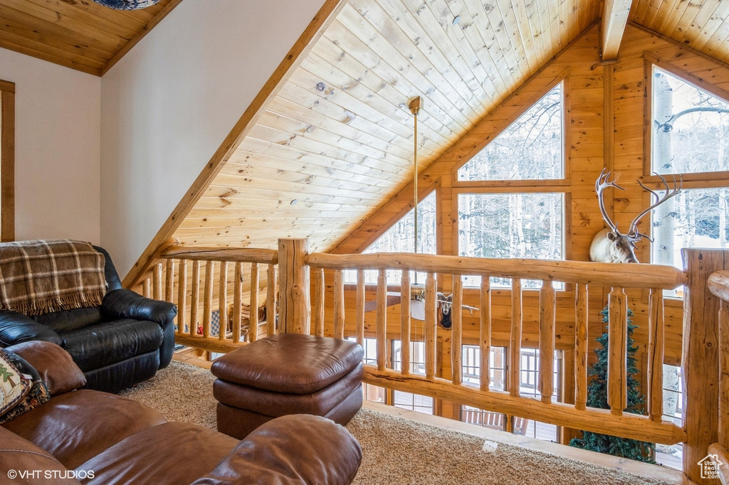 Living area featuring high vaulted ceiling and wooden ceiling