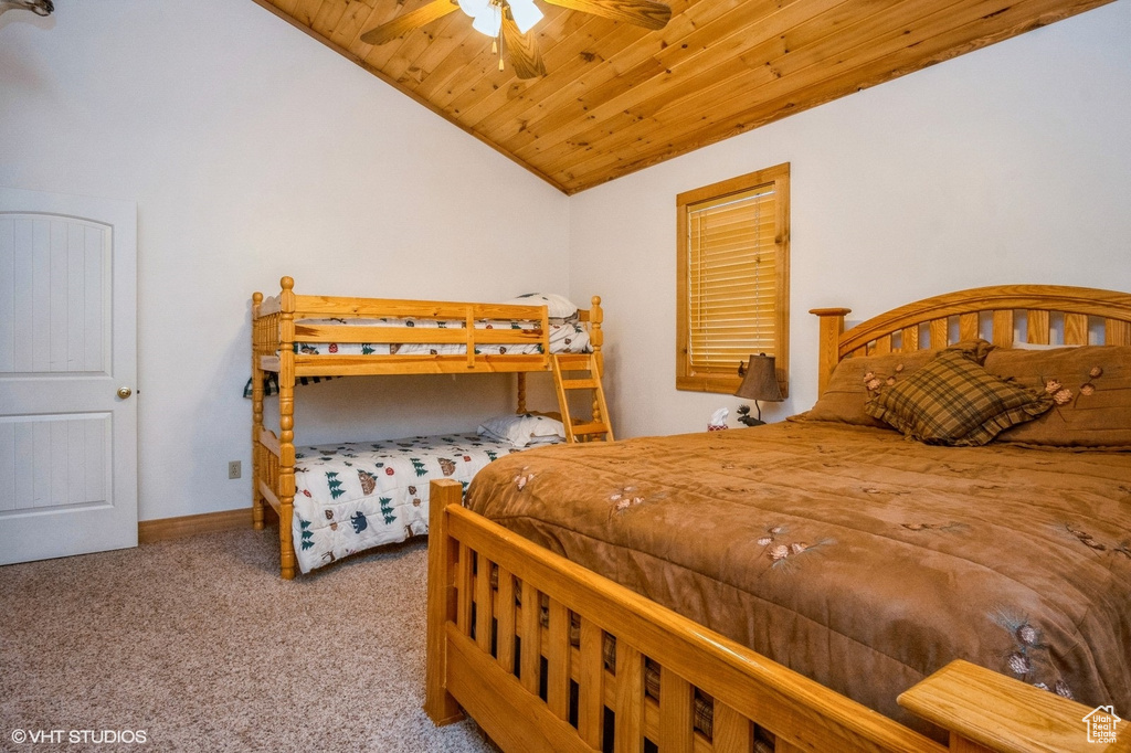 Bedroom featuring wood ceiling, a ceiling fan, vaulted ceiling, baseboards, and carpet floors
