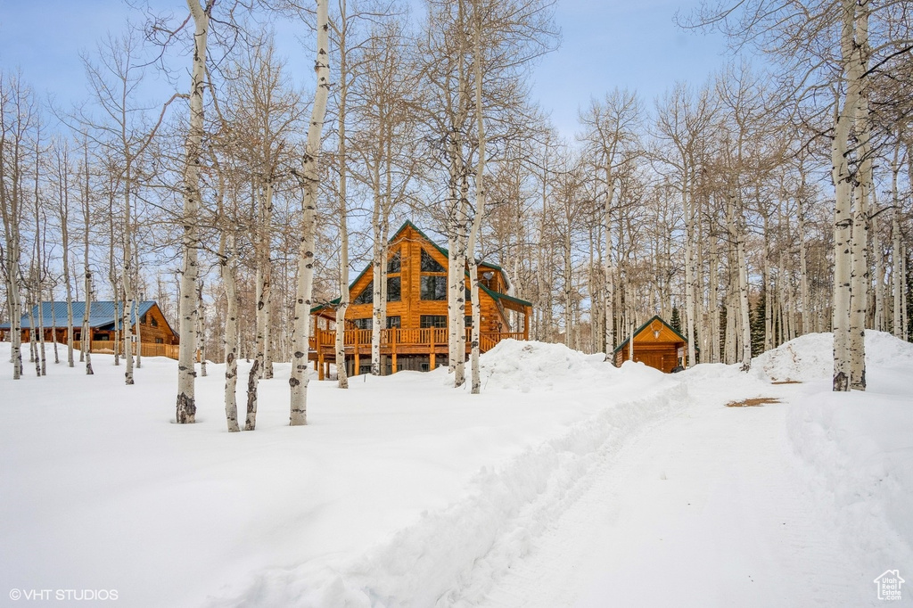 View of snow covered back of property