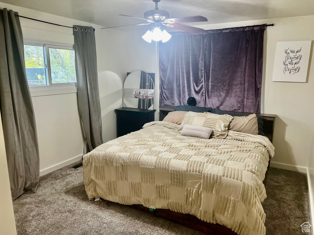Carpeted bedroom with baseboards and ceiling fan