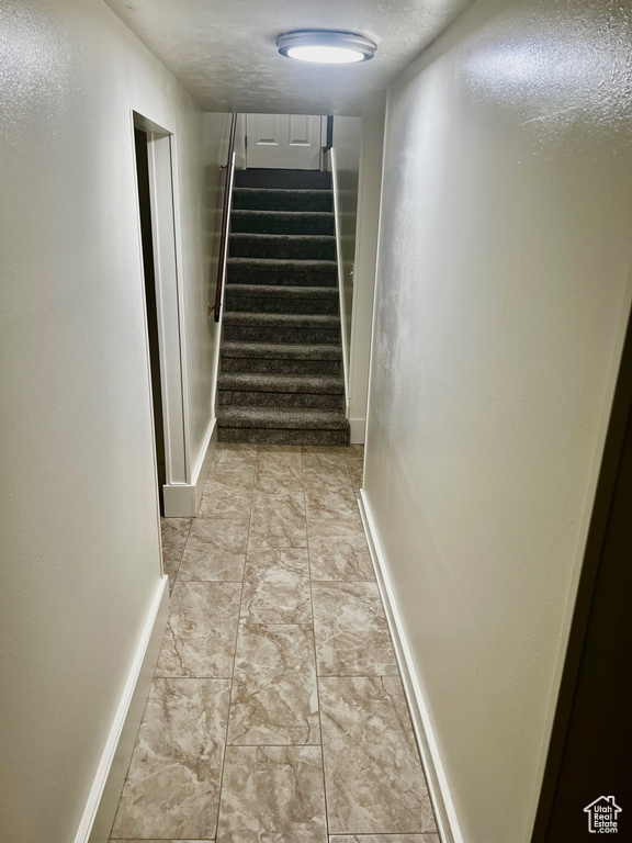 Staircase featuring baseboards