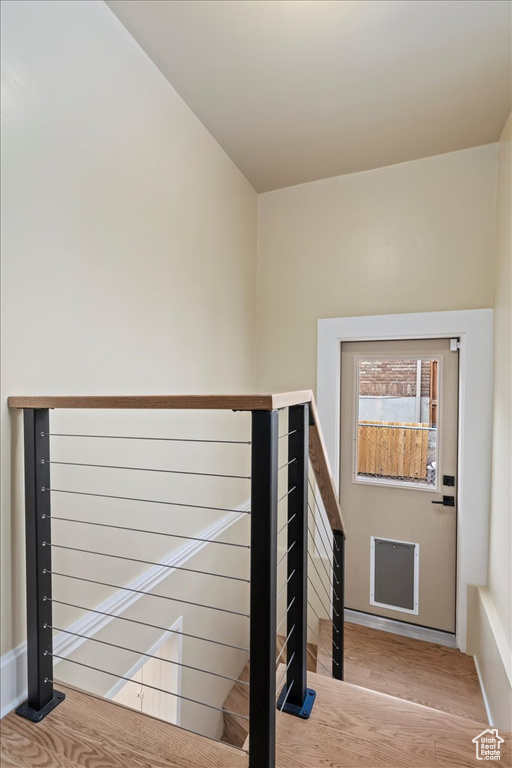 Stairs with baseboards and wood finished floors