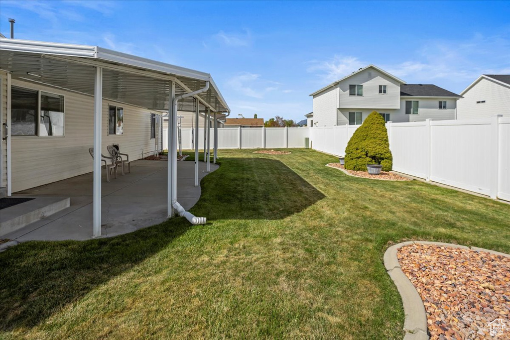 View of yard with a patio and a fenced backyard