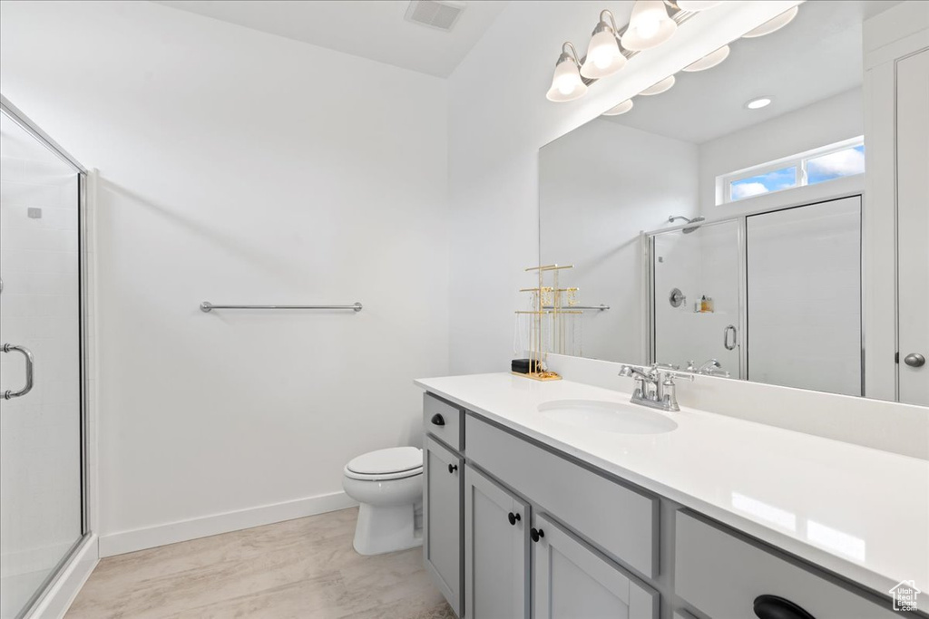 Full bathroom featuring visible vents, a stall shower, and vanity