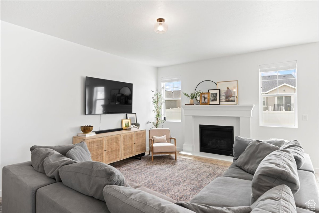 Living room with a fireplace and wood finished floors