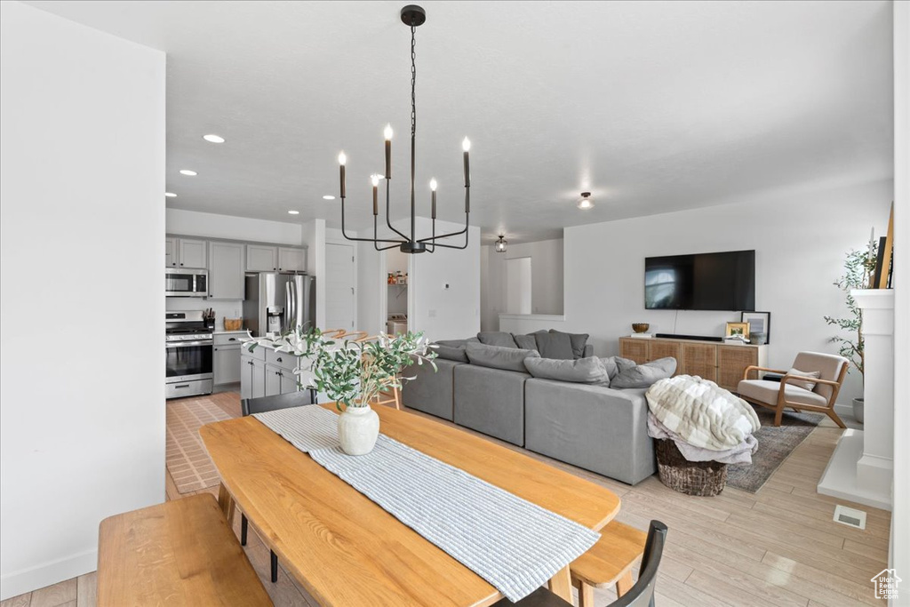 Dining room featuring visible vents, recessed lighting, a notable chandelier, and light wood-style floors