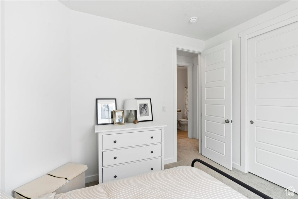 Bedroom with light colored carpet