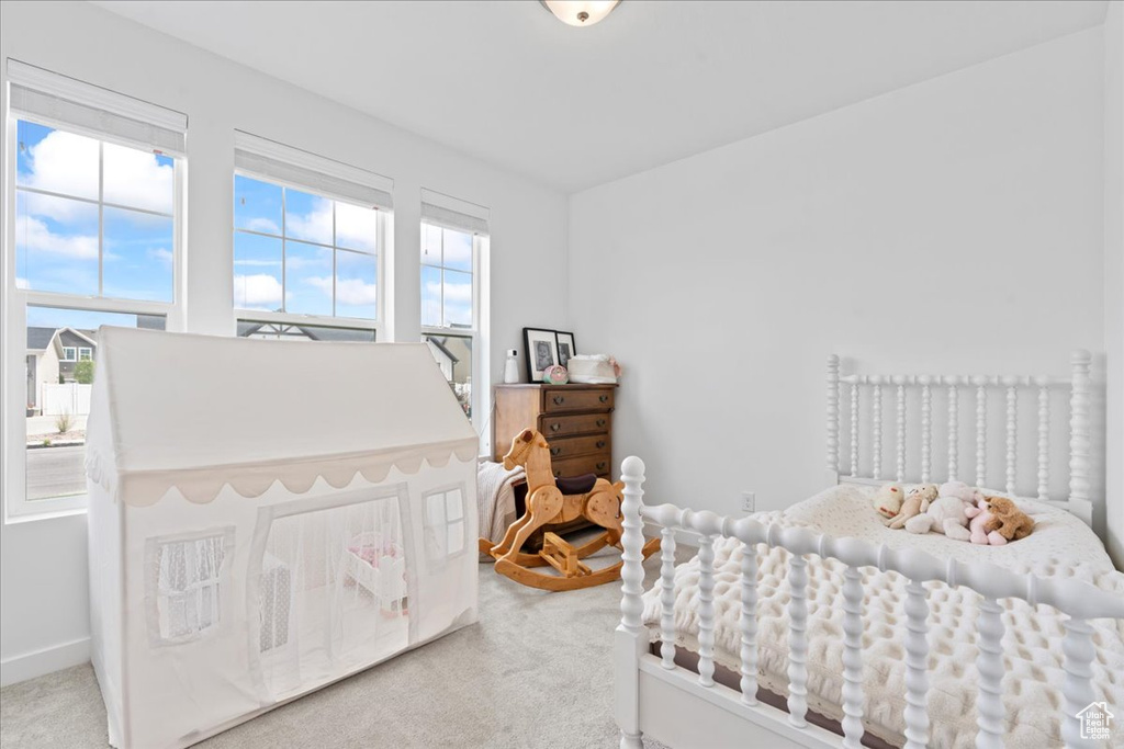 Bedroom featuring baseboards and carpet