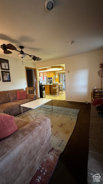Living area featuring a ceiling fan