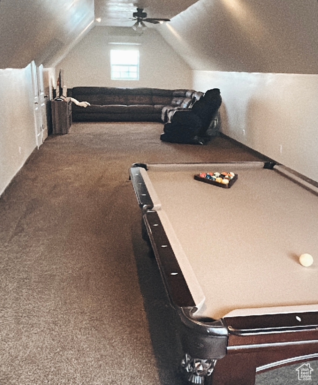 Recreation room with ceiling fan, vaulted ceiling, and carpet