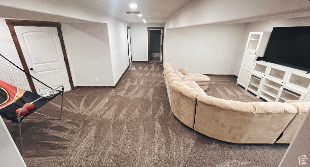 Carpeted living room with recessed lighting, baseboards, and visible vents
