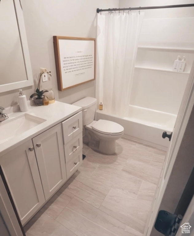 Full bathroom featuring vanity, shower / bathtub combination with curtain, and toilet
