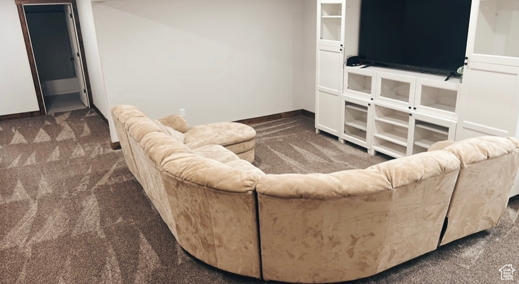 Living area featuring carpet floors and baseboards