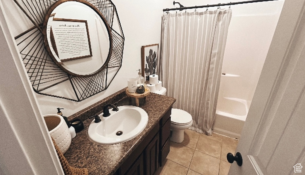 Full bathroom featuring vanity, tile patterned floors, shower / bath combination with curtain, and toilet