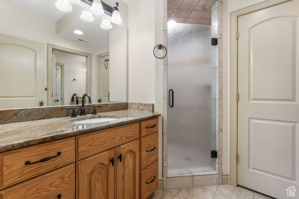 Full bath with visible vents, tile patterned floors, a stall shower, and vanity