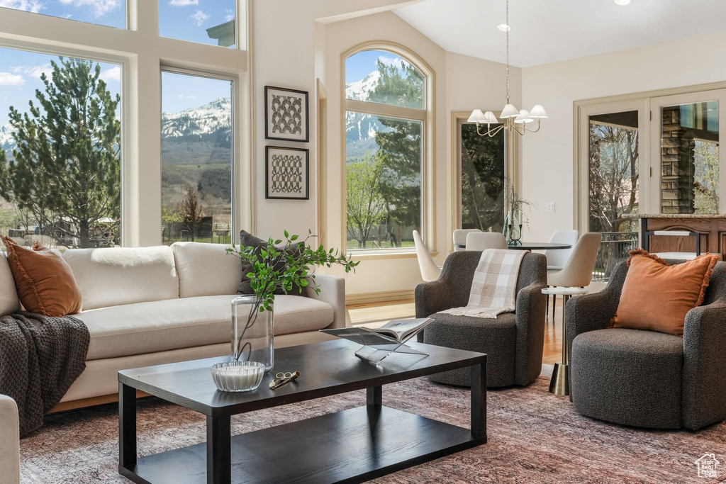 Sunroom / solarium with an inviting chandelier and a mountain view