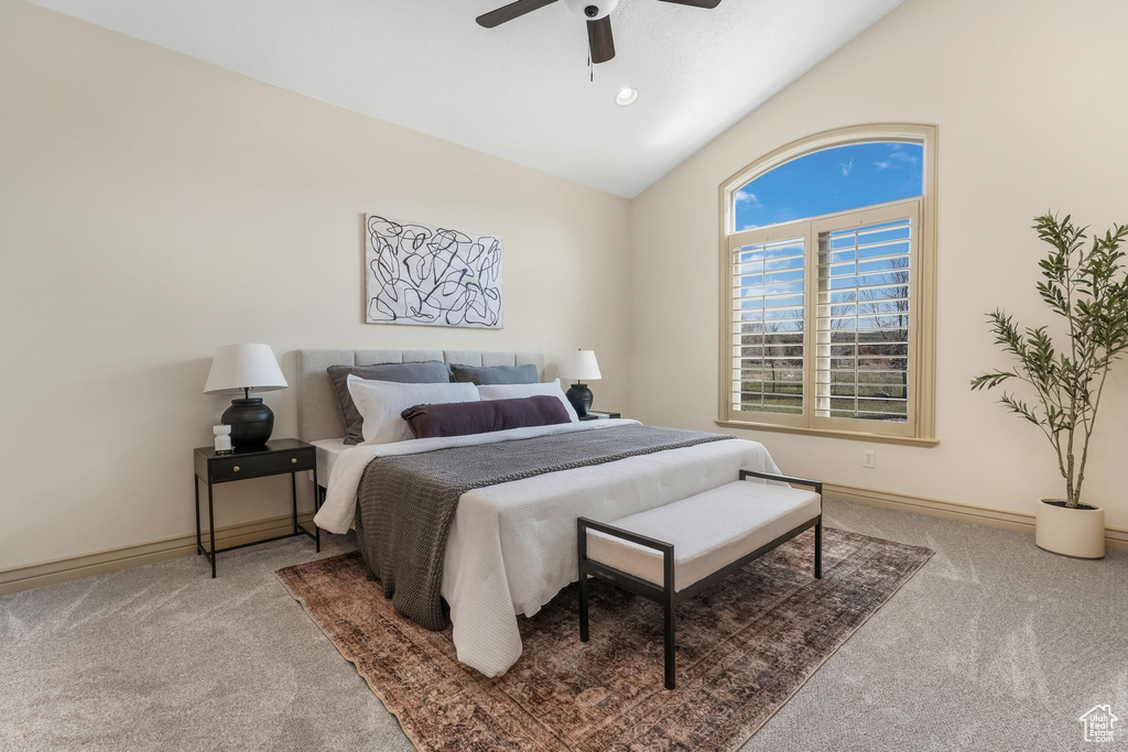 Bedroom featuring carpet floors, ceiling fan, baseboards, and lofted ceiling