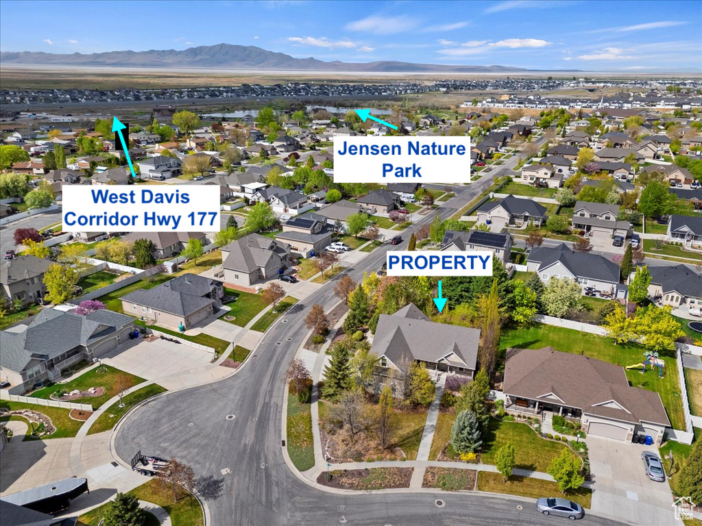 Aerial view of residential area featuring a mountainous background