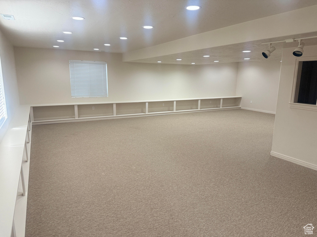 Carpeted spare room featuring recessed lighting and baseboards