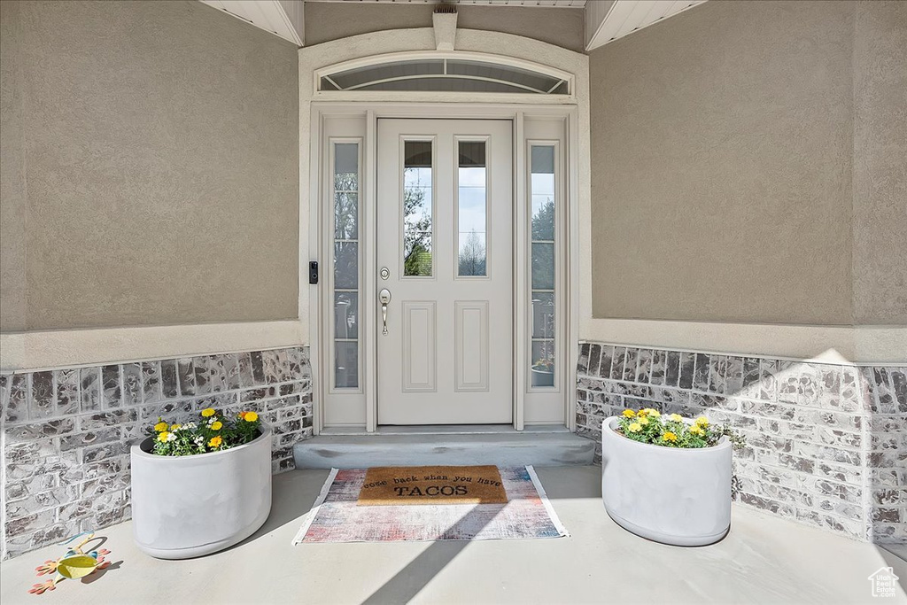 Entrance to property featuring stucco siding