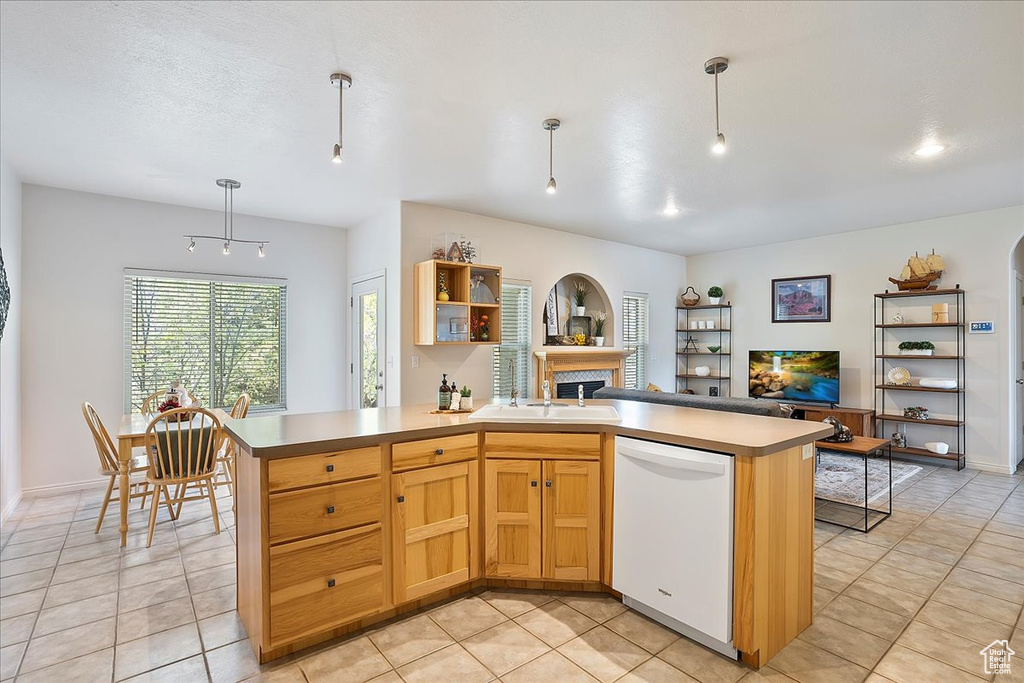 Kitchen with a sink, a fireplace, light tile patterned floors, white dishwasher, and open shelves