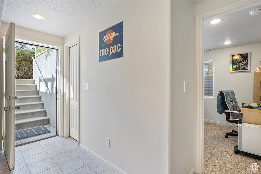 Interior space featuring recessed lighting, stairs, a textured ceiling, and baseboards