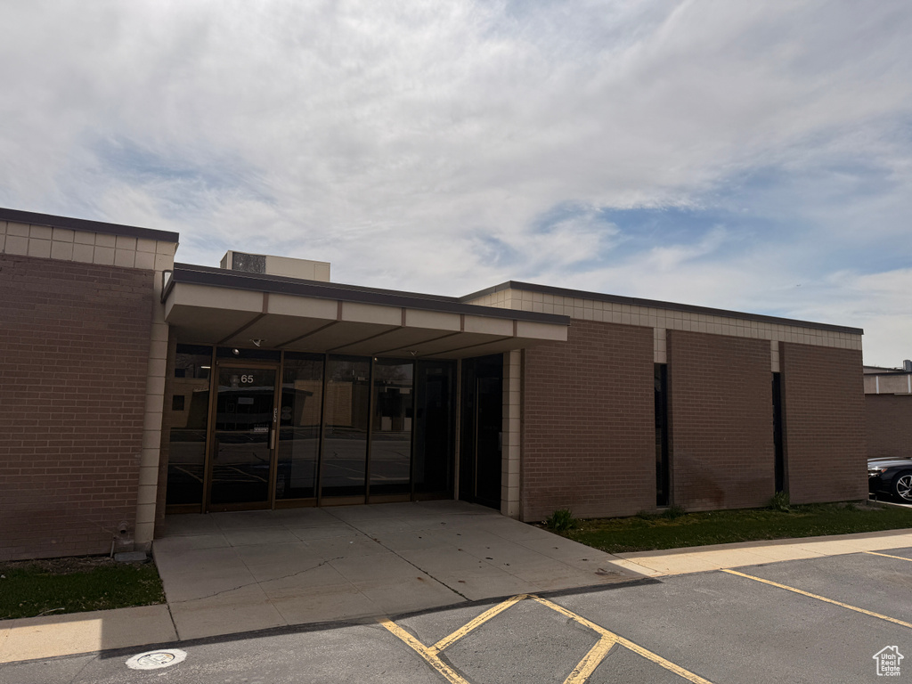 View of building exterior with uncovered parking