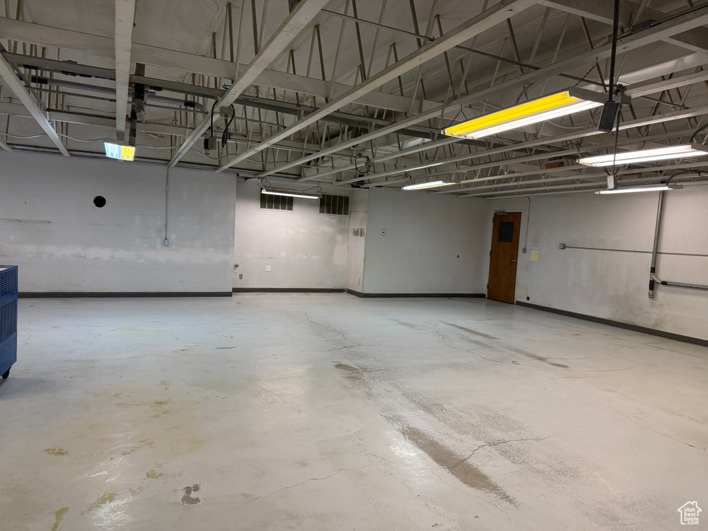 Parking garage featuring visible vents and baseboards