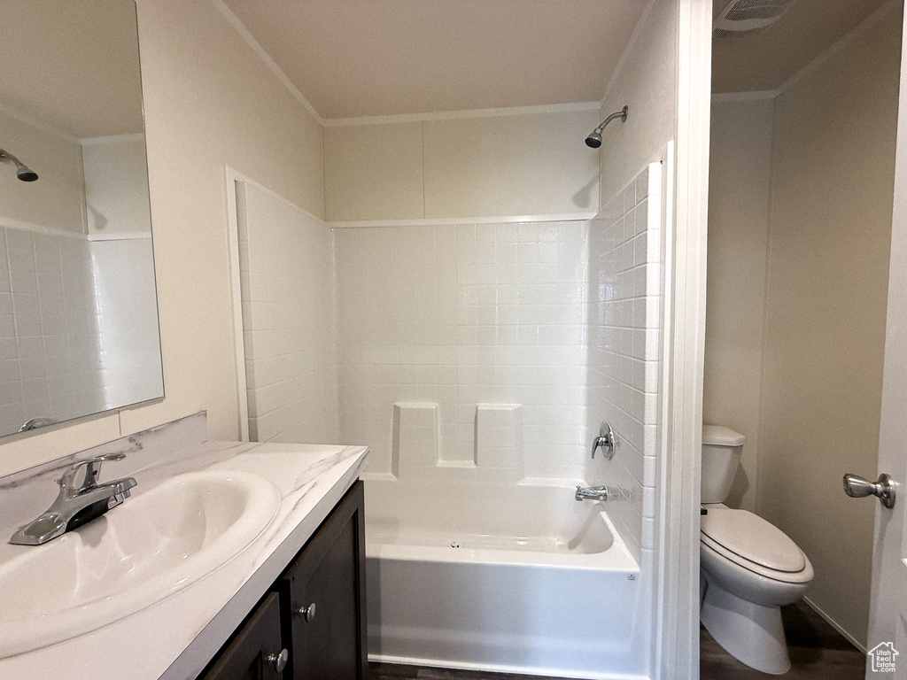 Bathroom featuring visible vents, toilet, bathtub / shower combination, and vanity