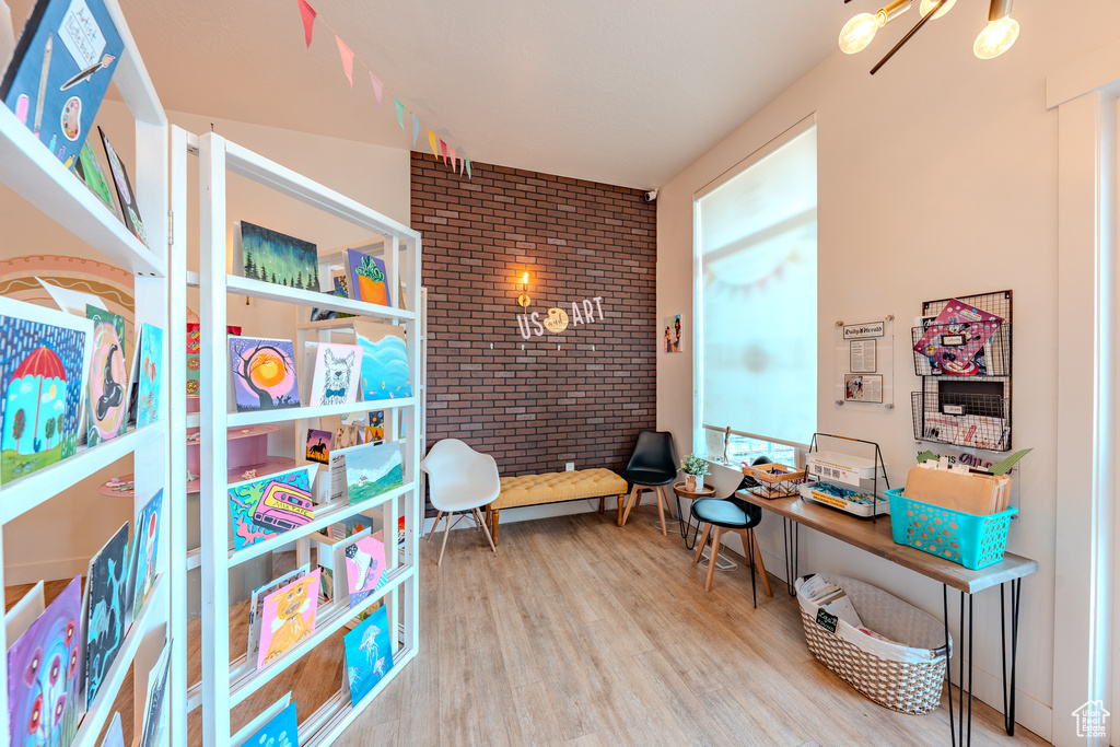 Interior space featuring brick wall and wood finished floors