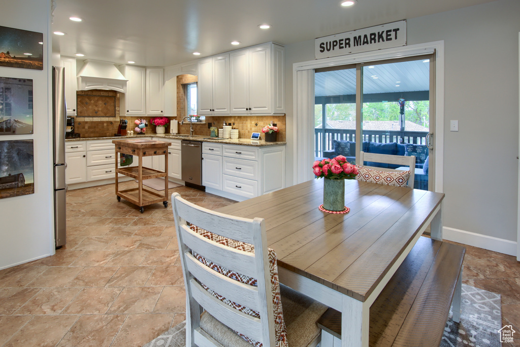 Dining space with baseboards, recessed lighting, and stone tile floors