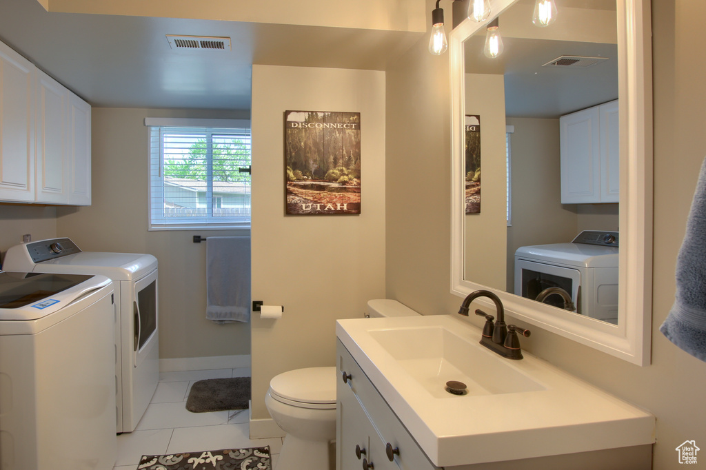 Bathroom with visible vents, tile patterned floors, toilet, and washing machine and clothes dryer