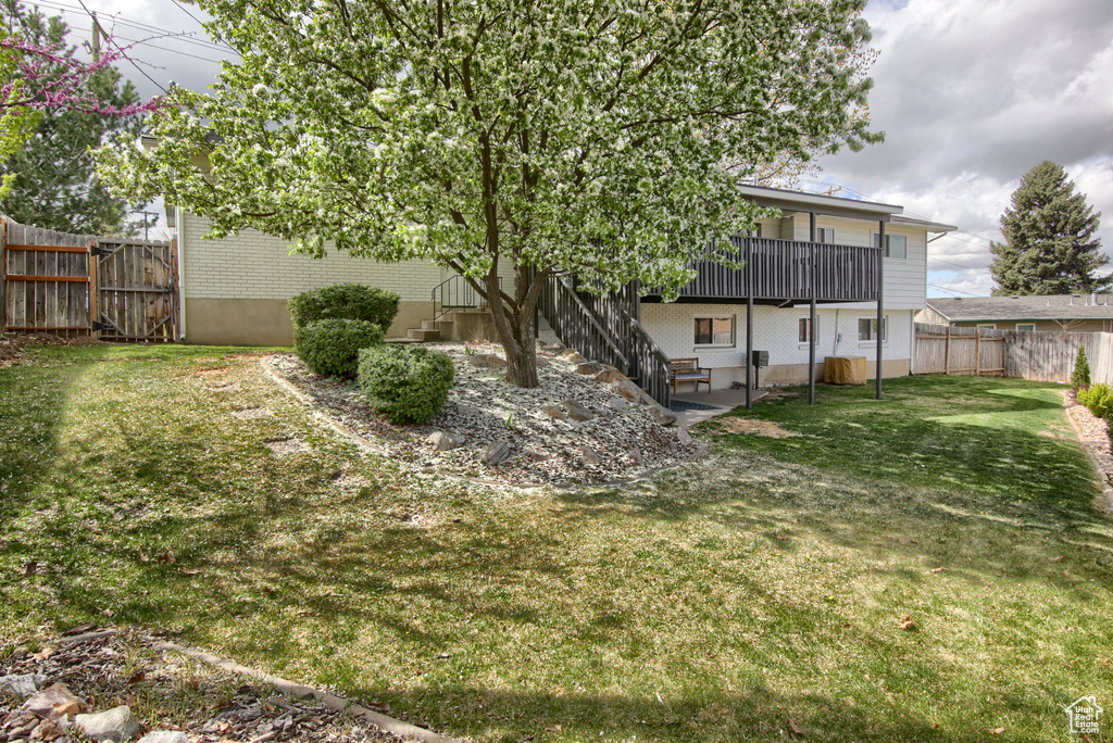 View of yard with a fenced backyard and a wooden deck